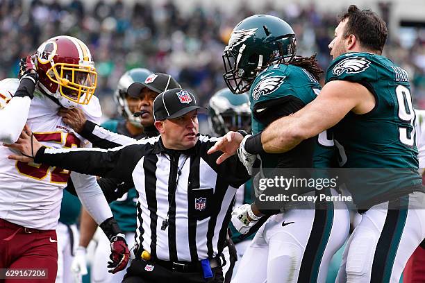 Line Judge Bart Longson breaks up a scuffle between Steven Means of the Philadelphia Eagles and Terence Garvin of the Washington Redskins as Connor...