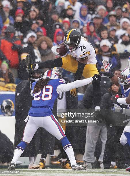 Le'Veon Bell of the Pittsburgh Steelers jumps over Ronald Darby of the Buffalo Bills during the second half at New Era Field on December 11, 2016 in...