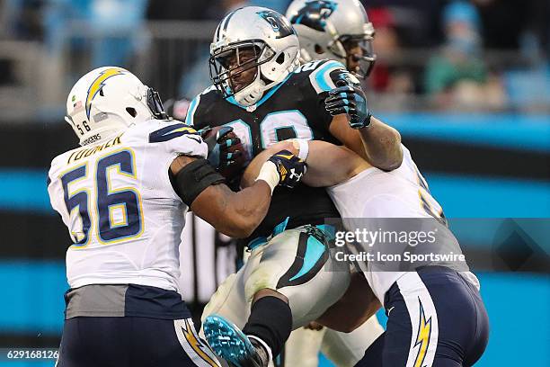 Carolina Panthers running back Jonathan Stewart is manhandled by San Diego Chargers inside linebacker Korey Toomer and outside linebacker Kyle...