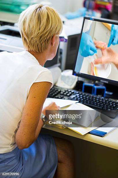 nurse in their office working with computer, - damaged phone stock pictures, royalty-free photos & images