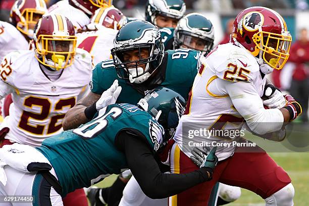 Chris Thompson of the Washington Redskins rushes against Jaylen Watkins and Marcus Smith both of the Philadelphia Eagles as Deshazor Everett of the...