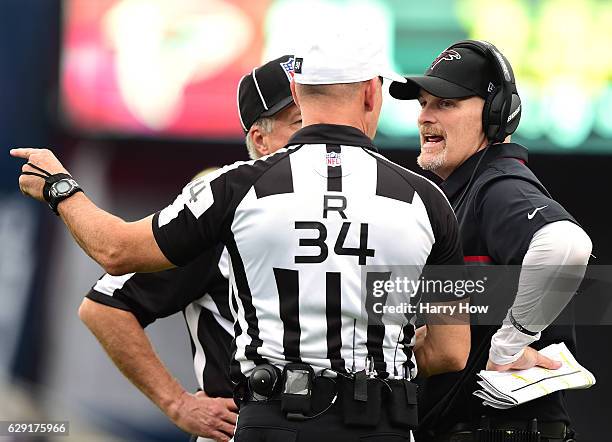 Head coach Dan Quinn of the Atlanta Falcons receives an explanation from referee Clete Blakeman during the second quarter against the Los Angeles...