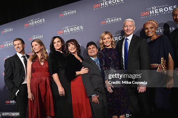 Kelly Ripa and Anderson Cooper pose with 2016 CNN Heroes Brad Ludden, Becca Stevens, Georgie Smith, Sherri Franklin, Jeison Aristizabal, and Umra...