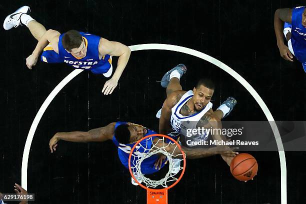 Isaiah Briscoe of the Kentucky Wildcats puts up a layup over Jamall Robinson of the Hofstra Pride in the second half of the Brooklyn Hoops Winter...