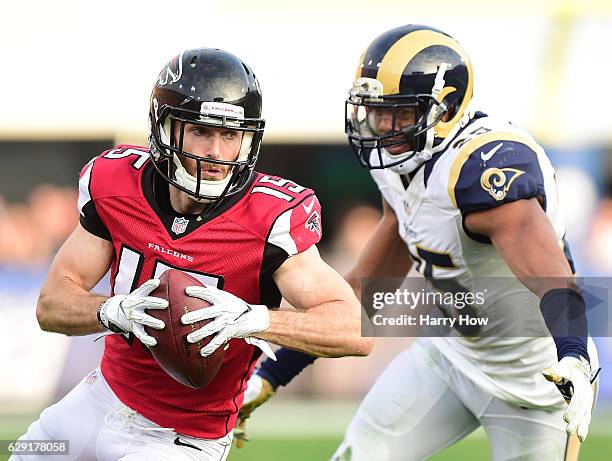 Nick Williams of the Atlanta Falcons runs after his catch past T.J. McDonald of the Los Angeles Rams during the third quarter at Los Angeles Memorial...