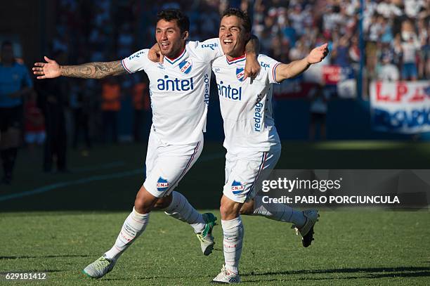 Sebastian Fernandez and Tabare Viudez of Nacional celebrate after winning the Uruguayan Special Tournament football match against Boston River and...