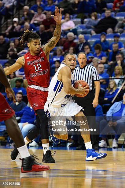 Indiana State Sycamores Guard Brenton Scott drives the ball past Western Kentucky Hilltoppers Guard Pancake Thomas during the game on December 11 at...