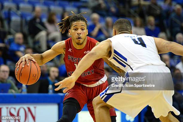 Western Kentucky Hilltoppers Guard Pancake Thomas dribbles up the court as Indiana State Sycamores Guard Brenton Scott plays defense during the game...
