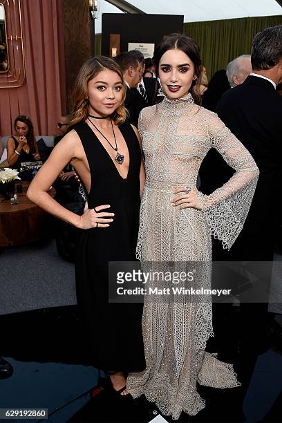 Actresses Sarah Hyland and Lily Collins attend The 22nd Annual Critics' Choice Awards at Barker Hangar on December 11, 2016 in Santa Monica,...