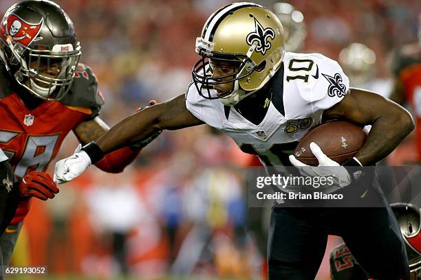 Wide receiver Brandin Cooks of the New Orleans Saints fends off middle linebacker Kwon Alexander of the Tampa Bay Buccaneers during a carry in the...