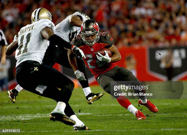 Running back Doug Martin of the Tampa Bay Buccaneers evades strong safety Roman Harper of the New Orleans Saints during a carry in the fourth quarter...