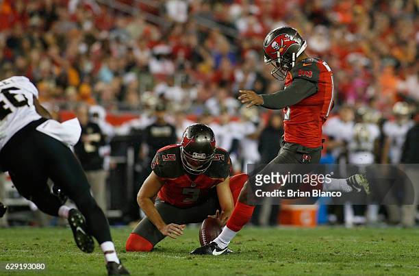 Kicker Roberto Aguayo of the Tampa Bay Buccaneers gets the hold from punter Bryan Anger as he kicks a 26 yard field goal during the fourth quarter of...
