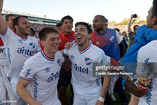 Rafael Garcia, Santiago Romero, Jorge Fucile, Luis Mejia and Diego Polenta of Nacional celebrate the Campeonato Uruguayo title after winning a match...