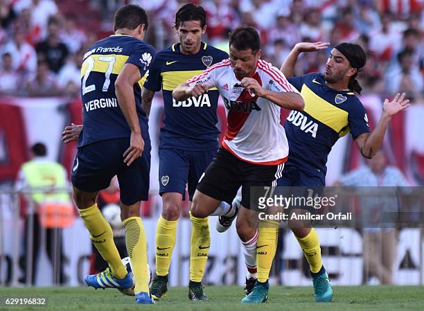Rodrigo Mora of River Plate fights for the ball with Fernando Gago, Santiago Vergini and Sebastian Perez of Boca Juniors during a match between River...