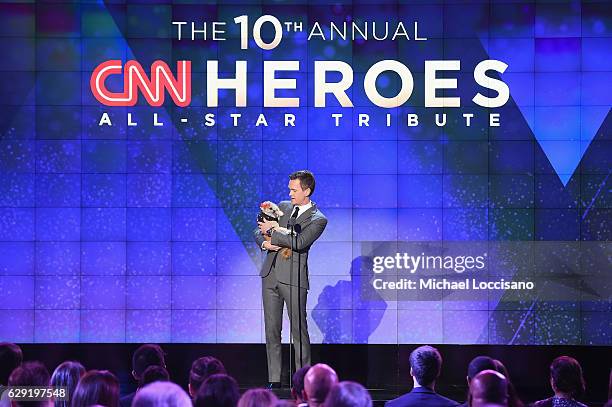 Neil Patrick Harris with a dog, speaks onstage during the CNN Heroes Gala 2016 at the American Museum of Natural History on December 11, 2016 in New...