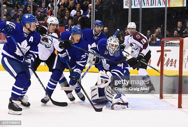 Antoine Bibeau of the Toronto Maple Leafs is helped by teammates Leo Komarov, Nikita Soshnikov and Nazem Kadri as Rene Bourque and Patrick Wiercioch...