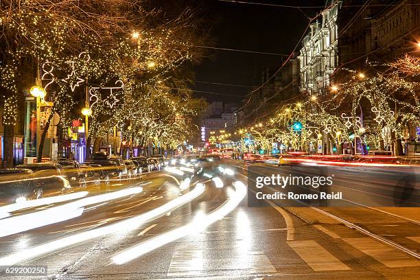 traffic flows on the christmas decorated budapest 2 - budapest street stock pictures, royalty-free photos & images