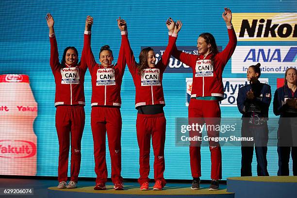 Team Canada celebrates their silver medal in the 4x100m Medley Relay on day six of the 13th FINA World Swimming Championships at the WFCU Centre on...