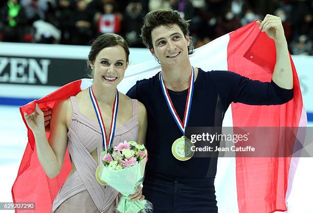 Gold medalists Tessa Virtue and Scott Moir of Canada pose during the medal ceremony for Senior Ice Dance on day three of the ISU Grand Prix of Figure...