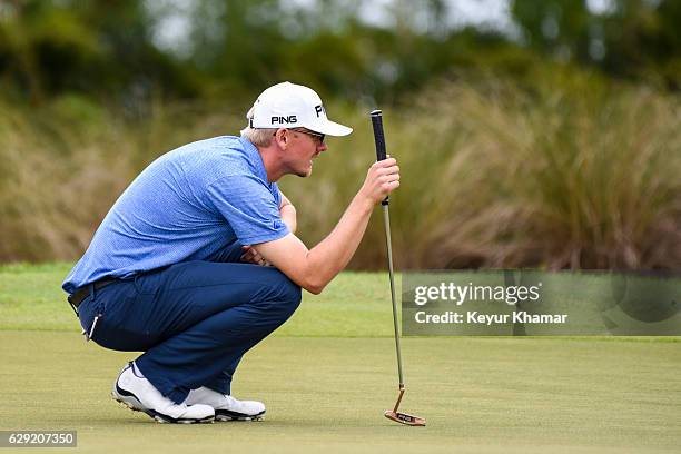 Jim Knous reads his putt on the 17th hole green on the Crooked Cat Course during the final round of Web.com Tour Q-School at Orange County National...