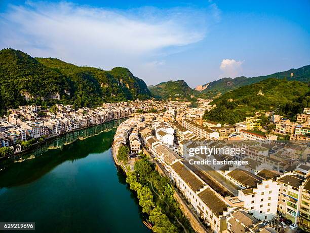 ws aerial shot of traditional houses and bridge on wuyang river,guizhou,china. - kaili stock-fotos und bilder