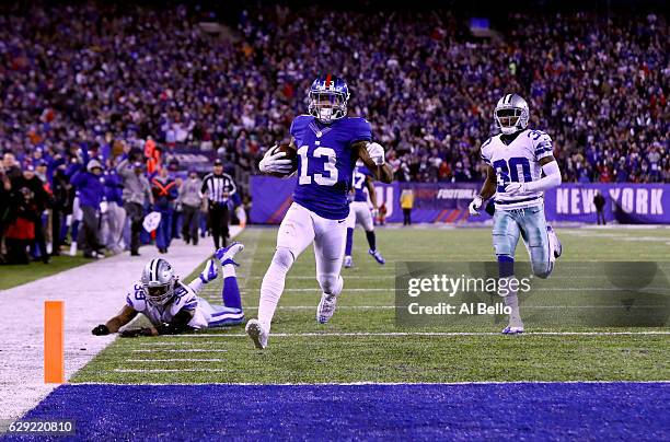 Odell Beckham Jr. #13 of the New York Giants scores a 61 yard touchdown against the Dallas Cowboys during the third quarter of the game at MetLife...