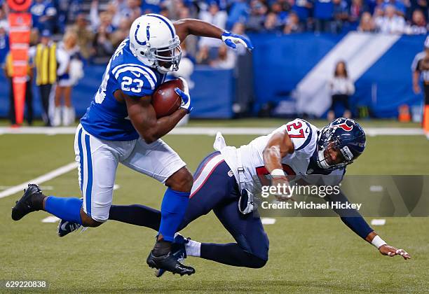 Frank Gore of the Indianapolis Colts runs for a touchdown as Quintin Demps of the Houston Texans attempts the tackle at Lucas Oil Stadium on December...