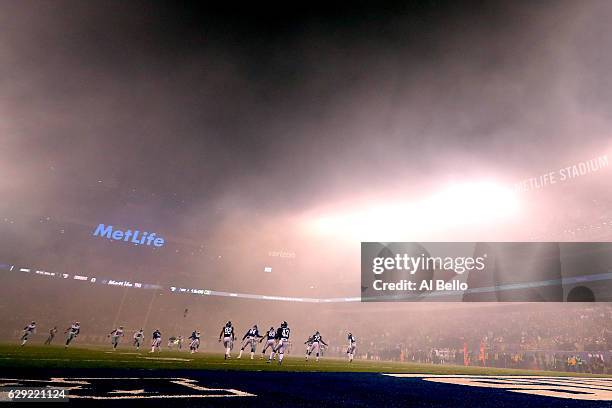 Bobby Rainey of the New York Giants runs with the ball after Dan Bailey of the Dallas Cowboys kicked the ball off to start the game at MetLife...