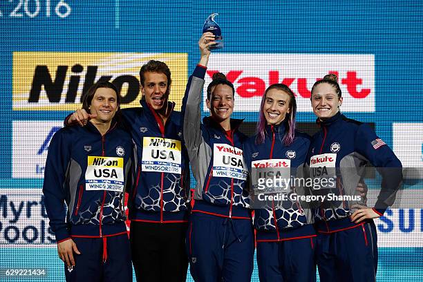 Cody Miller, Tom Shields, Amanda Weir, Madison Kennedy and Kelsi Worrell celebrate with the trophy for the best team of the meet on day six of the...