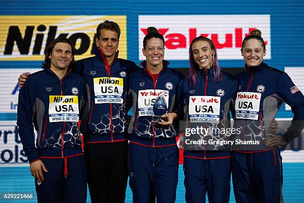 Cody Miller, Tom Shields, Amanda Weir, Madison Kennedy and Kelsi Worrell celebrate with the trophy for the best team of the meet on day six of the...