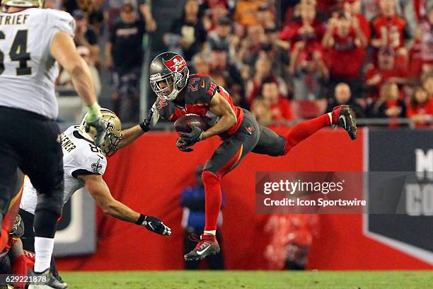 Brent Grimes of the Buccaneers leaps up and makes an interception of the Saints Drew Brees during the NFL Game between the New Orleans Saints and...