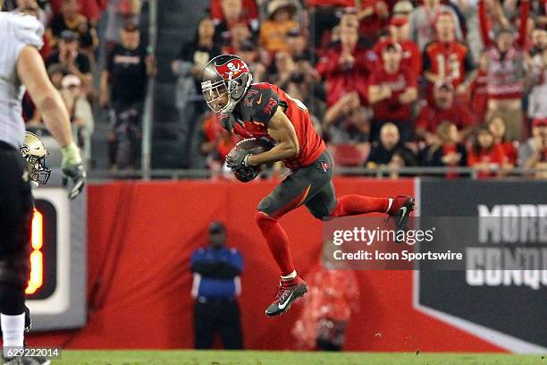 Brent Grimes of the Buccaneers leaps up and makes an interception of the Saints Drew Brees during the NFL Game between the New Orleans Saints and...