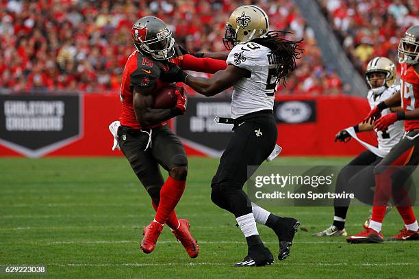 Tampa Bay Buccaneers wide receiver Josh Huff tries to break free from New Orleans Saints outside linebacker Dannell Ellerbe after catching a pass...