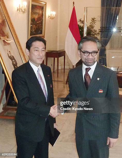 Indonesia - Japanese Foreign Minister Fumio Kishida shakes hands with Indonesian Foreign Minister Marty Natalegawa before their talks in Jakarta on...