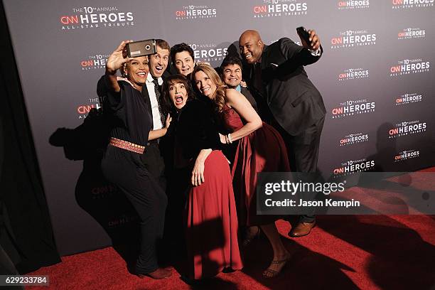 Heroes Umra Omar, Brad Ludden, Sherri Franklin, Luma Mufleh, Becca Stevens, and Sheldon Smith take a selfie during the CNN Heroes Gala 2016 at the...