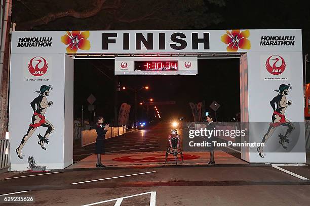 Wheelchair participant Masazumi Soejima crosses the finish line during the Honolulu Marathon 2016 on December 11, 2016 in Honolulu, Hawaii.