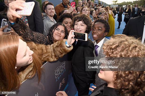 Actors Finn Wolfhard, Caleb McLaughlin and Gaten Matarazzo attend The 22nd Annual Critics' Choice Awards at Barker Hangar on December 11, 2016 in...