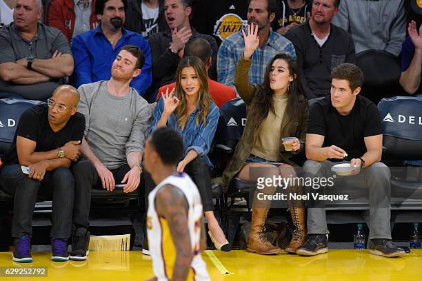 Bryan Greenberg, Jamie Chung, Chloe Bridges and Adam DeVine attend a basketball game between the New York Knicks and the Los Angeles Lakers at...