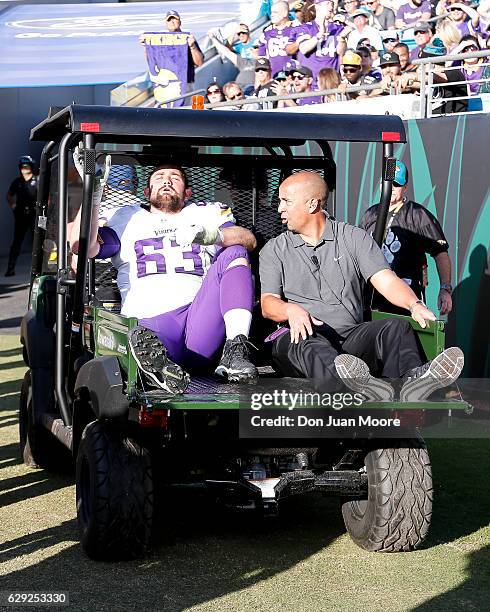 Guard Brandon Fusco of the Minnesota Vikings is carted off the field during the game against the Jacksonville Jaguars at EverBank Field on December...