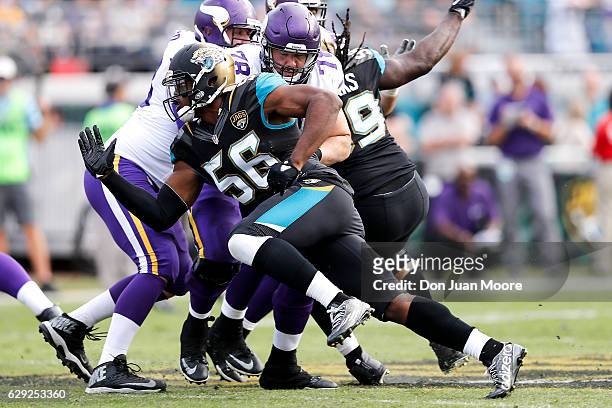 Defensive End Dante Fowler, Jr. #56 of the Jacksonville Jaguars blows past Tackle Jeremiah Sirles of the Minnesota Vikings during the game at...