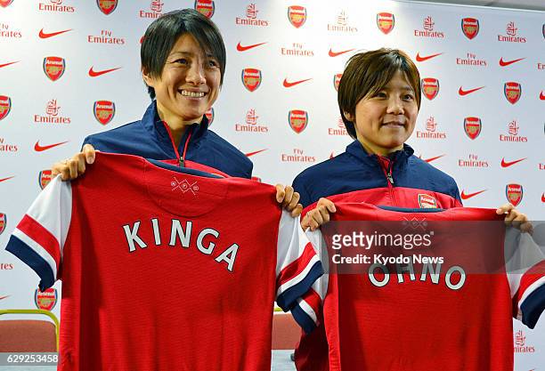 Britain - Yukari Kinga and Shinobu Ono, members of the "Nadeshiko Japan" women's national soccer team, pose for photos at a press conference in...