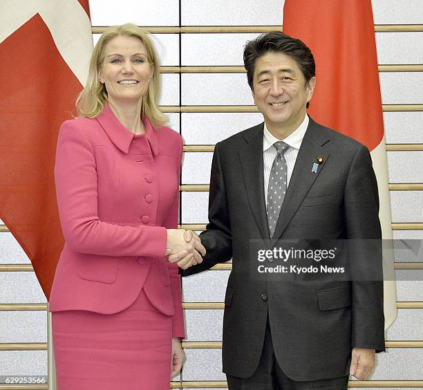 Japan - Japanese Prime Minister Shinzo Abe shakes hands with his Danish counterpart Helle Thorning-Schmidt ahead of their talks at Abe's office in...