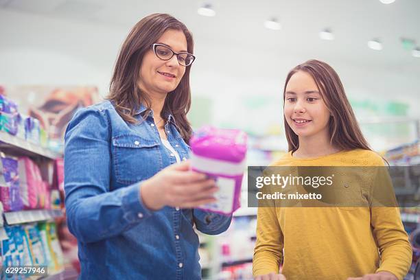 mother and daughter shopping sanitary pad - sanitary napkins stock pictures, royalty-free photos & images