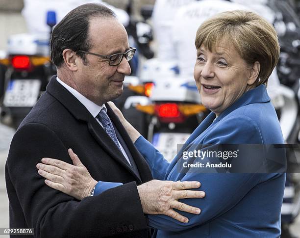 German Chancellor Angela Merkel welcomes French President Francois Hollande before their meeting at Schloss Herrenhausen palace in Hanover, Germany...