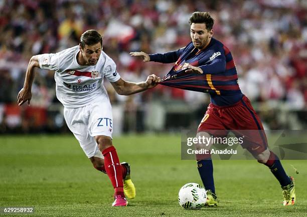 Lionel Messi of Barcelona in action against Grzegorz Krychowiak of Sevilla during the Copa del Rey Final match between FC Barcelona and Sevilla FC at...