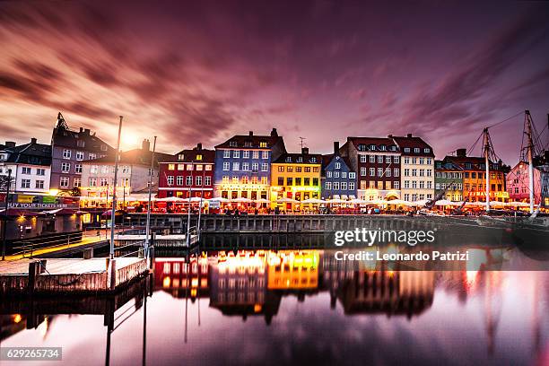 copenhagen famous canal with boats and typical architecture - copenhagen nyhavn stock pictures, royalty-free photos & images