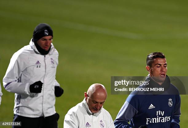 Real Madrid's French headcoach Zinedine Zidane , fitness coach Antonio Pintus and Portuguese forward Christiano Ronaldo run during a training session...