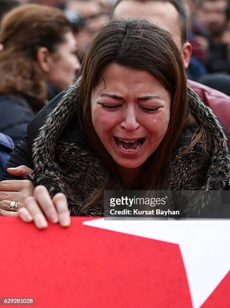 Relative of police officer Erdem Ozcelik who was killed in bomb attacks outside the Vodafone Stadium in Besiktas on December 10 mourns over his...