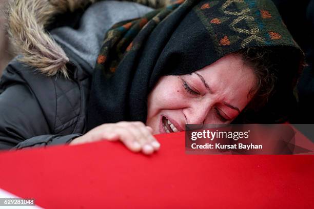 Relative of police officer Erdem Ozcelik who was killed in bomb attacks outside the Vodafone Stadium in Besiktas on December 10 mourns over his...