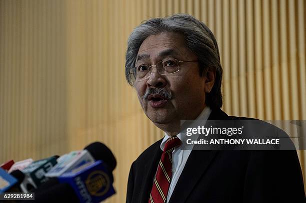 Hong Kong financial secretary John Tsang speaks at a press conference to announce his resignation in Hong Kong on December 12, 2016. Tsang --...